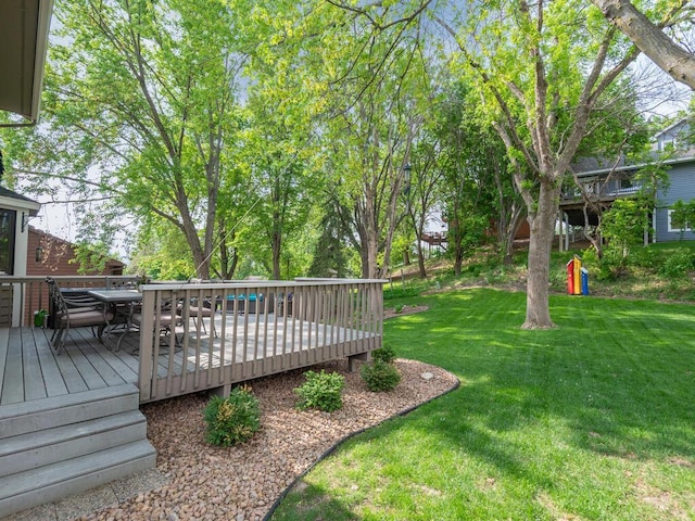 5705 Quinwood Ln N, Plymouth, MN 55442 - view of grassy yard with a wooden deck and outdoor dining space