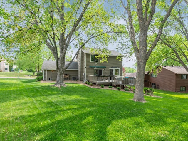 5705 Quinwood Ln N, Plymouth, MN 55442 - rear view of house with a deck and a lawn