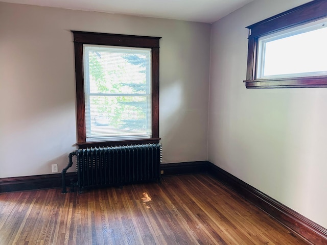 138 George St W, Saint Paul, MN 55107 - unfurnished room with radiator heating unit, wood finished floors, and baseboards