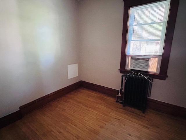 138 George St W, Saint Paul, MN 55107 - spare room with wood finished floors, baseboards, and cooling unit