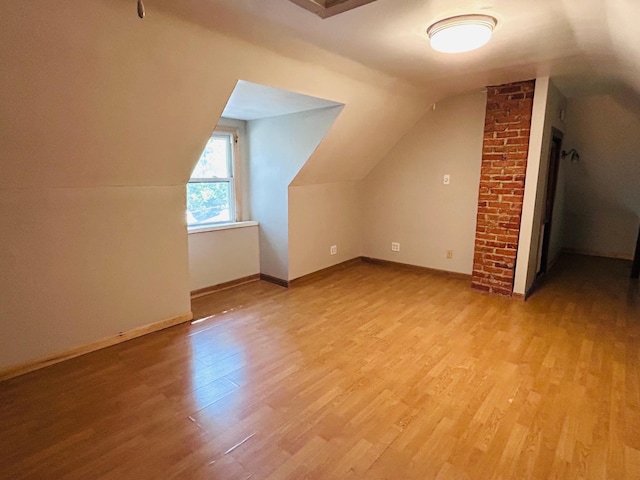 138 George St W, Saint Paul, MN 55107 - bonus room featuring light wood-style flooring, vaulted ceiling, and baseboards