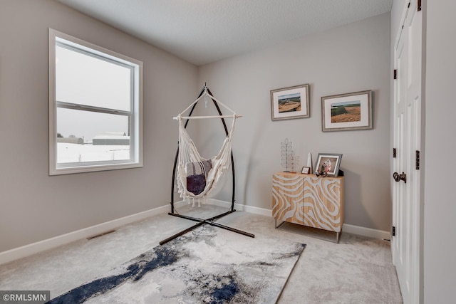 game room featuring carpet flooring, baseboards, and a textured ceiling