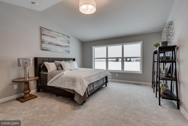 carpeted bedroom with lofted ceiling and baseboards