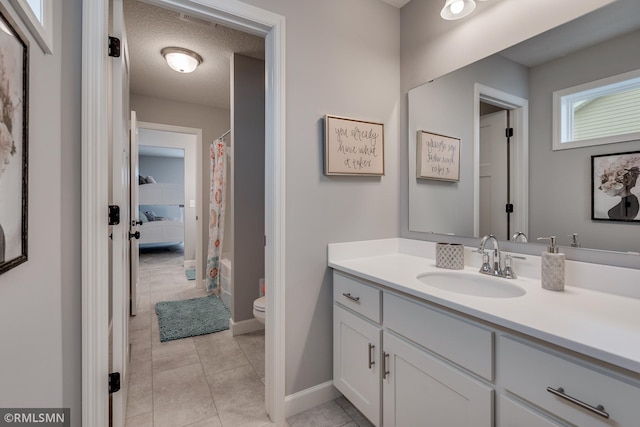 full bath featuring toilet, vanity, baseboards, curtained shower, and tile patterned flooring