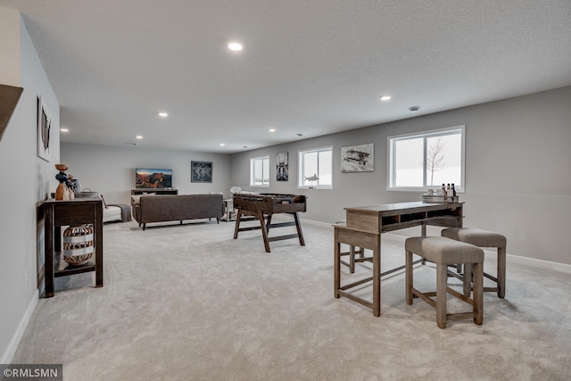 recreation room with recessed lighting, light colored carpet, baseboards, and a textured ceiling