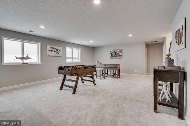 playroom with light carpet, a textured ceiling, recessed lighting, and baseboards