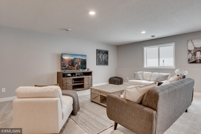 living area featuring light carpet, a textured ceiling, baseboards, and recessed lighting
