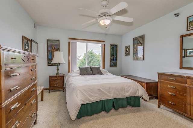 bedroom with light carpet and a ceiling fan