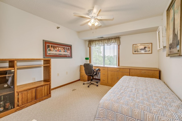 carpeted bedroom featuring baseboards and ceiling fan