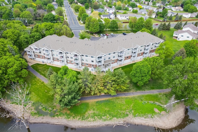 drone / aerial view of a large body of water and a tree filled landscape