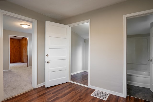 608 7th Ave S, Hopkins, MN 55343 - unfurnished bedroom featuring dark wood-style floors and baseboards