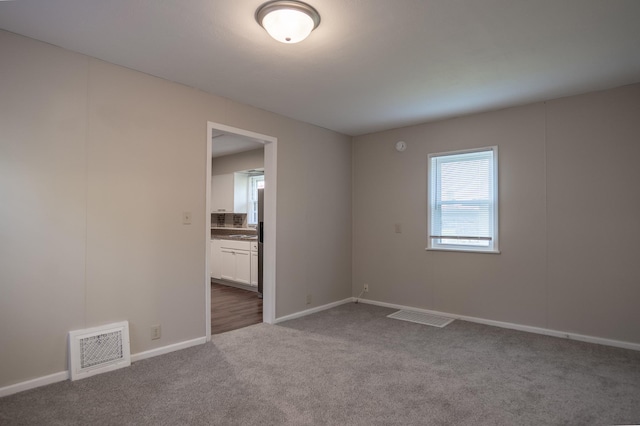 608 7th Ave S, Hopkins, MN 55343 - unfurnished room featuring carpet floors and baseboards