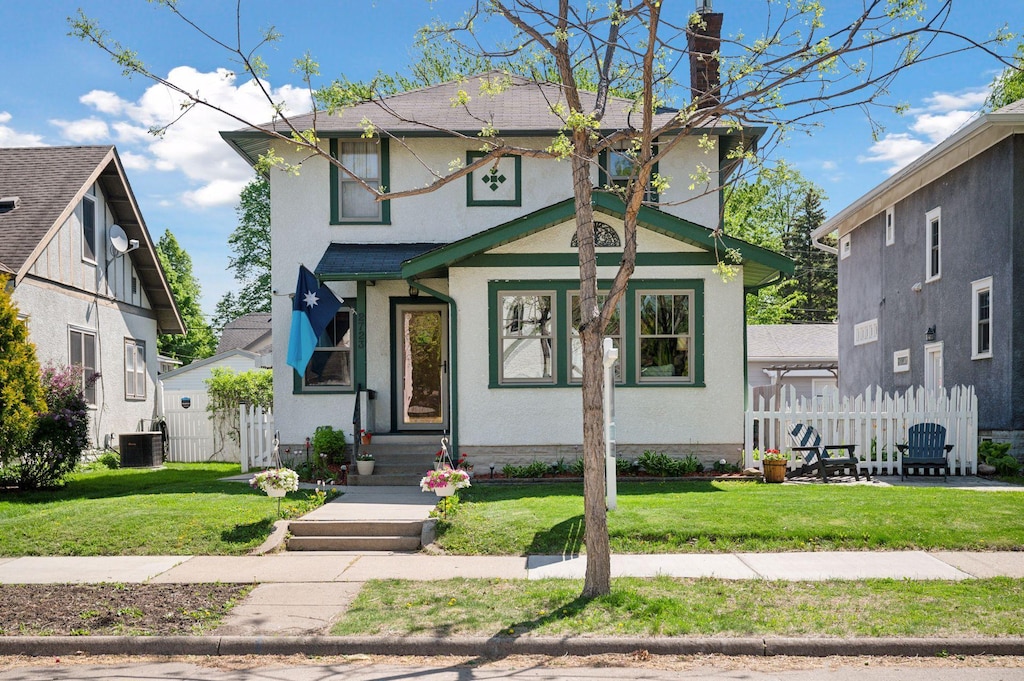 2723 Garfield St NE, Minneapolis, MN 55418 - view of front of property featuring stucco siding, a chimney, and central AC