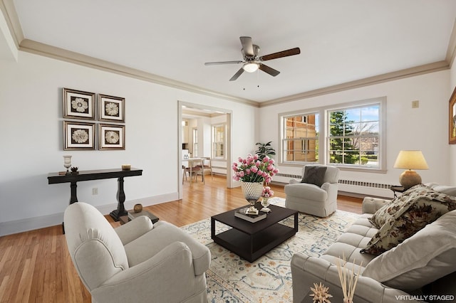 2615 Park Ave Unit 120, Minneapolis, MN 55407 - living area with a ceiling fan, a baseboard radiator, light wood finished floors, baseboards, and crown molding