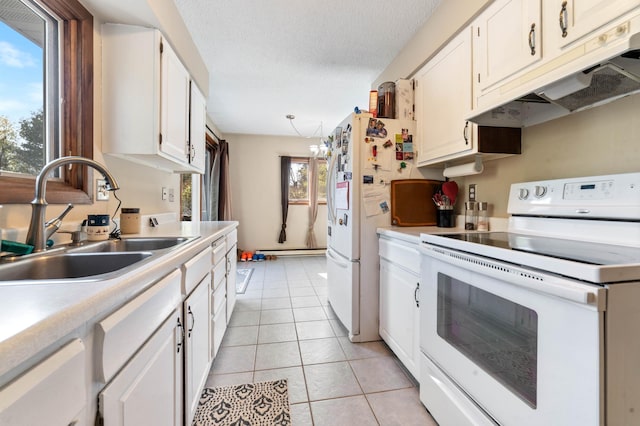 kitchen with white appliances, under cabinet range hood, a sink, light countertops, and white cabinetry