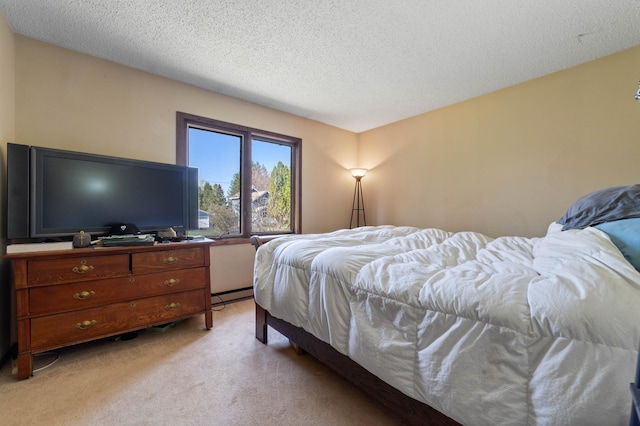 bedroom with light carpet, baseboard heating, and a textured ceiling