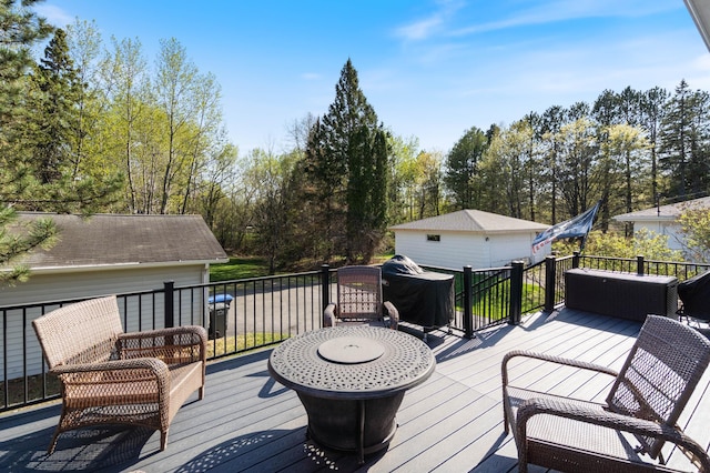 wooden deck with view of wooded area