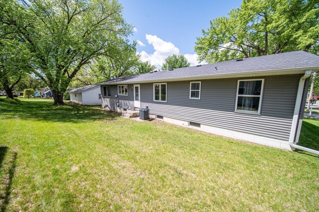 306 Hiawatha Dr E, Wabasha, MN 55981 - back of property with a lawn, central AC unit, and a shingled roof