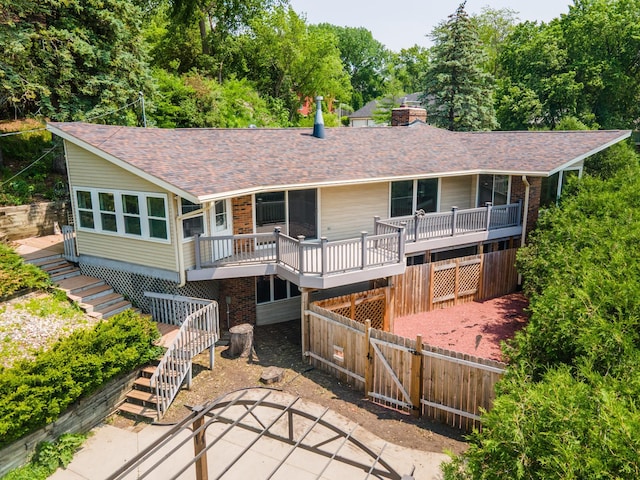1723 Teton Ln NE, Rochester, MN 55906 - back of property featuring stairs, a gate, a chimney, roof with shingles, and a deck