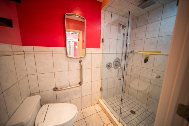 1723 Teton Ln NE, Rochester, MN 55906 - full bathroom with a shower stall, toilet, tile walls, and tile patterned floors