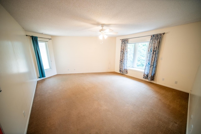 1723 Teton Ln NE, Rochester, MN 55906 - unfurnished room with plenty of natural light, a ceiling fan, carpet flooring, and a textured ceiling