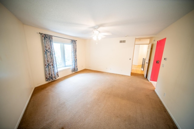 1723 Teton Ln NE, Rochester, MN 55906 - spare room featuring a ceiling fan, light colored carpet, and baseboards