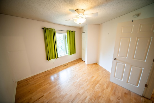 1723 Teton Ln NE, Rochester, MN 55906 - spare room with light wood-style floors, ceiling fan, a textured ceiling, and baseboards