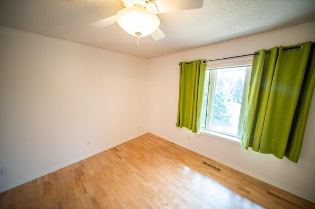 1723 Teton Ln NE, Rochester, MN 55906 - unfurnished room with light wood finished floors, baseboards, a ceiling fan, and a textured ceiling