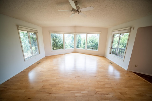 1723 Teton Ln NE, Rochester, MN 55906 - spare room featuring a textured ceiling, light wood-style floors, baseboards, and ceiling fan