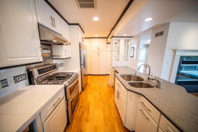1723 Teton Ln NE, Rochester, MN 55906 - kitchen featuring appliances with stainless steel finishes, a sink, tile counters, under cabinet range hood, and recessed lighting