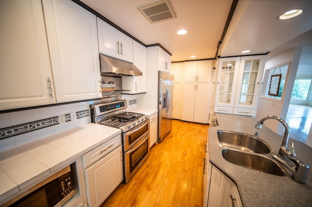 1723 Teton Ln NE, Rochester, MN 55906 - kitchen with appliances with stainless steel finishes, under cabinet range hood, a sink, white cabinetry, and recessed lighting