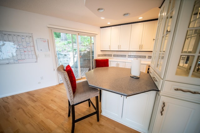 1723 Teton Ln NE, Rochester, MN 55906 - kitchen with light wood finished floors, white cabinets, recessed lighting, and a breakfast bar area