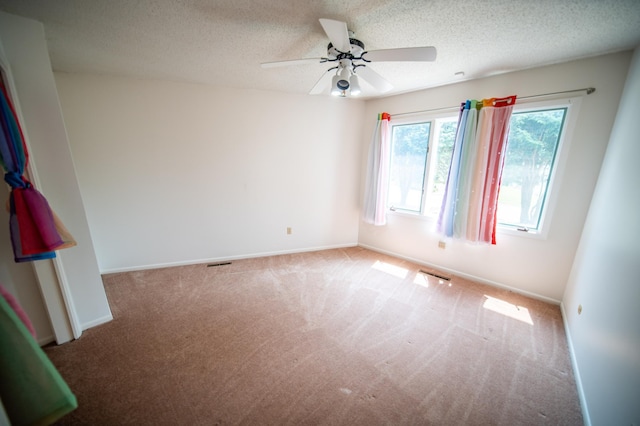 1723 Teton Ln NE, Rochester, MN 55906 - unfurnished room featuring carpet flooring, baseboards, a textured ceiling, and ceiling fan