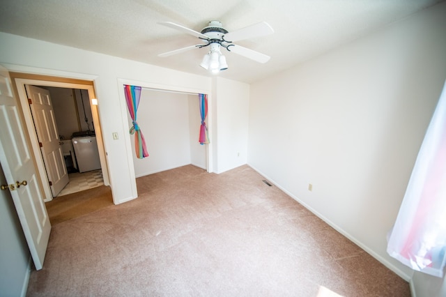 1723 Teton Ln NE, Rochester, MN 55906 - unfurnished bedroom featuring light colored carpet, separate washer and dryer, a closet, a ceiling fan, and baseboards