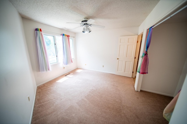 1723 Teton Ln NE, Rochester, MN 55906 - unfurnished room with carpet flooring, ceiling fan, a textured ceiling, and baseboards