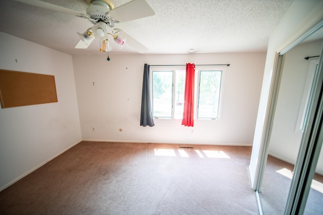 1723 Teton Ln NE, Rochester, MN 55906 - unfurnished room with carpet flooring, a ceiling fan, a textured ceiling, and baseboards