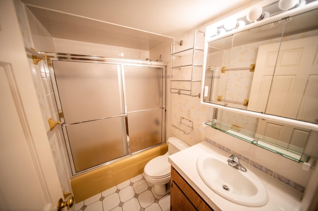 1723 Teton Ln NE, Rochester, MN 55906 - bathroom featuring combined bath / shower with glass door, vanity, toilet, and tile patterned floors