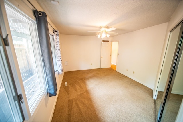 1723 Teton Ln NE, Rochester, MN 55906 - unfurnished bedroom with multiple windows, carpet flooring, a textured ceiling, a closet, and baseboards