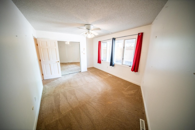 1723 Teton Ln NE, Rochester, MN 55906 - carpeted empty room with ceiling fan, baseboards, and a textured ceiling