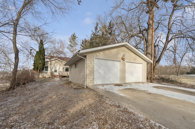 309 2nd Ave SE, New London, MN 56273 - view of side of home with a garage, an outdoor structure, and a deck
