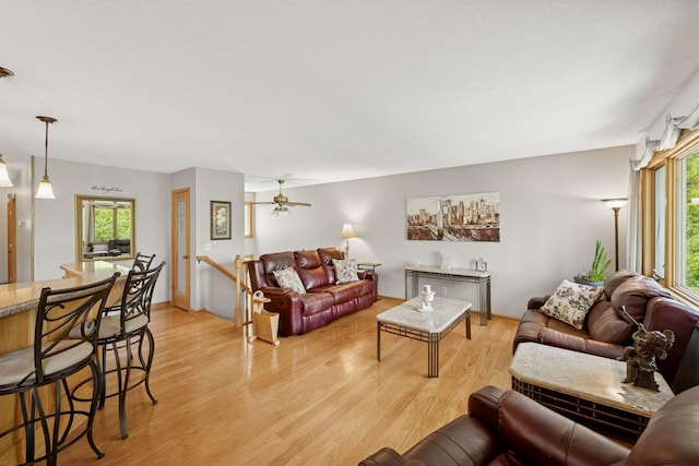 1301 Crestridge Ln, Eagan, MN 55123 - living area featuring plenty of natural light, light wood finished floors, a ceiling fan, and baseboards