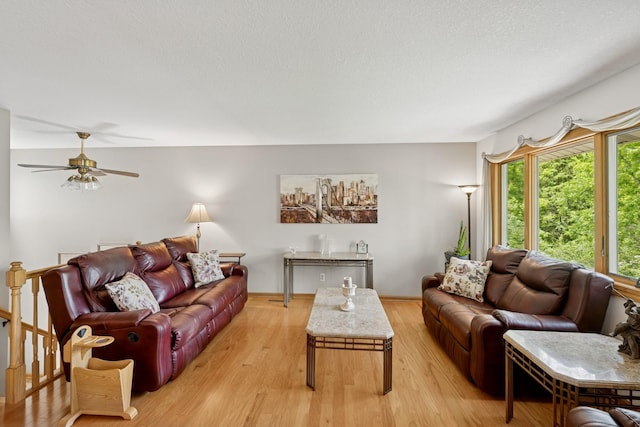 1301 Crestridge Ln, Eagan, MN 55123 - living area with ceiling fan, light wood-style flooring, a textured ceiling, and baseboards