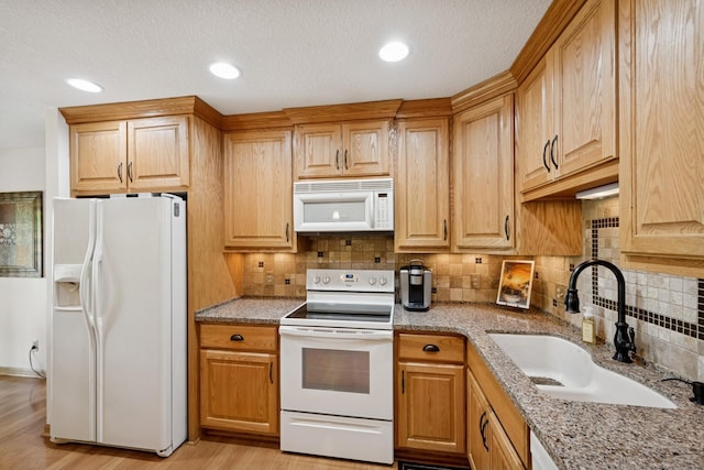 1301 Crestridge Ln, Eagan, MN 55123 - kitchen with white appliances, a sink, tasteful backsplash, light stone counters, and recessed lighting