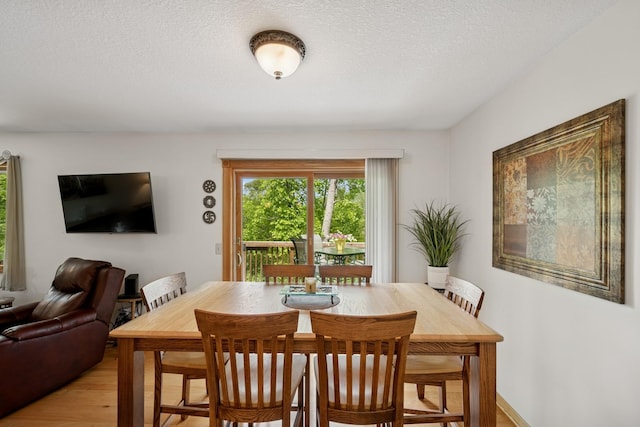 1301 Crestridge Ln, Eagan, MN 55123 - dining room featuring light wood-style flooring and a textured ceiling