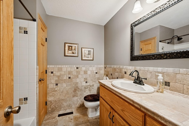 1301 Crestridge Ln, Eagan, MN 55123 - full bathroom with tile walls, toilet, vanity, a wainscoted wall, and  shower combination