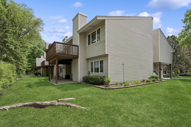 1301 Crestridge Ln, Eagan, MN 55123 - back of house featuring a chimney, a yard, a patio, and a wooden deck