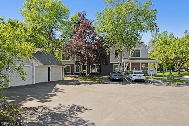 7475 110th St W, Bloomington, MN 55438 - view of front of property with an outdoor structure and uncovered parking