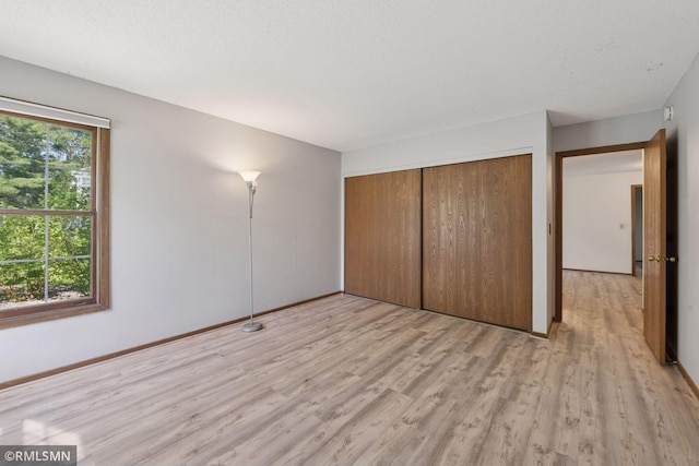 7475 110th St W, Bloomington, MN 55438 - unfurnished bedroom with light wood-type flooring, a closet, and baseboards