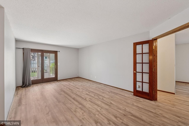 7475 110th St W, Bloomington, MN 55438 - empty room with french doors, wood finished floors, baseboards, and a textured ceiling