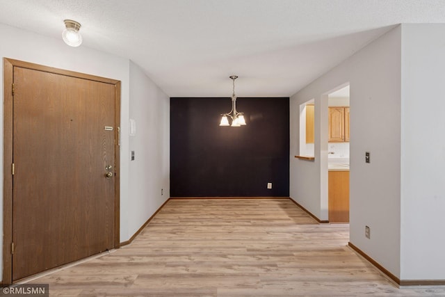 7475 110th St W, Bloomington, MN 55438 - entryway featuring light wood finished floors, baseboards, and a chandelier